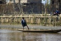 Burmese child poling a boat