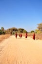 Burmese children boys novice group playing walking on gravel dirt dust road go to Shwezigon Pagoda Paya temple at Bagan or Pagan