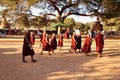 Burmese children boys novice group playing walking on gravel dirt dust road go to Shwezigon Pagoda Paya temple at Bagan or Pagan