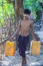 Burmese Farmer carrying plastic buckets filled with water