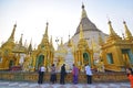 Burmese female devotees from various walks of life praying in Shwedagon Pagoda