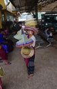 Burmese female Vendor selling straw hat to visitors on a hot weather