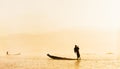 Burmese fisherman on bamboo boat catching fish in traditional wa Royalty Free Stock Photo