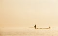 Burmese fisherman on bamboo boat catching fish in traditional wa Royalty Free Stock Photo