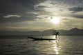 A Burmese fisherman carries his net on Inle Lake