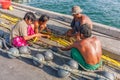 Burmese fishermen mending nets