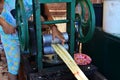 Burmese girl made sugar cane juice by maker manual machine for sale traveler Royalty Free Stock Photo