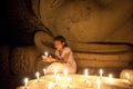 Burmese girl to pay her respect to the Buddha statue