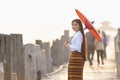 A Burmese girl walks on a bridge at a major tourist attraction in Mandalay Province, Myanmar Royalty Free Stock Photo