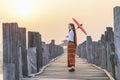 A Burmese girl walks on a bridge at a major tourist attraction in Mandalay Province, Myanmar Royalty Free Stock Photo