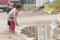Burmese kids playing in Puddle