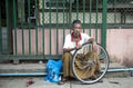 burmese man with a bicycle wheel
