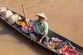 Burmese man on small long wooden boat selling souvenirs, trinkets and bijouterie at the floating market on Inle lake, Myanmar, Bur Royalty Free Stock Photo