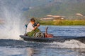 Close-up of a man at the helm of a long boat with motor sailing fast across Inle Lake, Myanmar, April 12th, 2018 Royalty Free Stock Photo