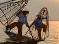 Burmese men catching fish on lake in Inle, Myanmar