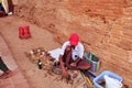 Burmese men craftsmanship people sit on floor carving wooden toy souvenir gift for sale travelers in Dhammayangyi paya or