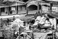 Burmese men loading and unloading sacks of supplies and food from boats to carts, in Inle Lake