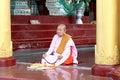 Burmese nuns sitting and praying in front of Shwedagon pagoda 1 of 5 sacred places