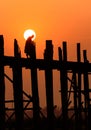 People crossing the longest teak bridge in the world, the iconic wooden U Bein Bridge during sunset, Mandalay, Myanmar Royalty Free Stock Photo