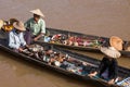 Burmese people on small long wooden boat selling souvenirs, trinkets and bijouterieat the floating market on Inle lake, Myanmar Royalty Free Stock Photo
