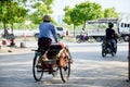 Burmese people and traffic on the road in Mandalay