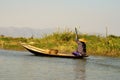 Burmese person in a boat on Inle Lake