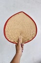 Burmese traditional bamboo fan holded by hand in a house of in myanmar.