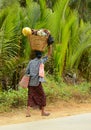 Burmese woman is carrying a bag on her head Royalty Free Stock Photo