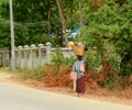 Burmese woman is carrying a bag on her head Royalty Free Stock Photo