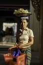 A Burmese woman placed a fruit tray on her head for sale in the temple area Royalty Free Stock Photo
