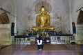 Burmese woman praying inside pagoda