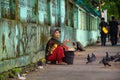 Burmese woman selling grains and seeds for pigeon food.