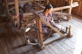 Burmese woman is spinnig a lotus thread