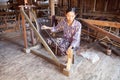 Burmese woman is spinnig a lotus thread