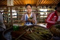 Burmese woman works making cheroot cigars in shop on Inle Lake