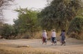 Burmese women biking on rural road in Bagan, Myanmar Royalty Free Stock Photo