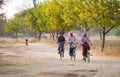 Burmese women biking on rural road in Inlay, Myanmar Royalty Free Stock Photo