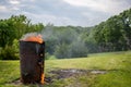 Burn barrel in a rural area used to incinerate trash and garbage. Royalty Free Stock Photo