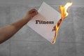 Burn fitness text on burning paper