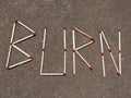 Burn Inscription Made of Matches Royalty Free Stock Photo