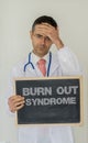 Burn out syndrome in healthcare personal concept. Depressed doctor with burnout syndrome. Royalty Free Stock Photo