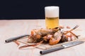 Burn shrim and Seafood sauce with beer on wooden table.