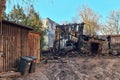 Burned barn, garage and car. Sunny spring day