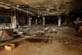 Burned building interior shows extensive damage after a fire, with charred debris and collapsed structures Royalty Free Stock Photo