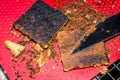 Burned cookie bars. Black overcooked sweet treat. Royalty Free Stock Photo