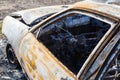 Burned down car, abstract background, selective focus. The situation of protests in the world Royalty Free Stock Photo