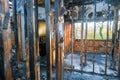 Burned house interior after fire burnt black timber roof structure building room inside Royalty Free Stock Photo