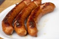 Burned Juicy sausage barbecue Sizzle on with Salt and Black Peppers on White Plate for Lunch BBQ Grilled for Picnic Royalty Free Stock Photo