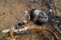 Burned motorcycle laying on the ground metal garbage background