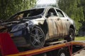 Burned-out car. Evacuation of vehicles after accident. Transportation of machine. Burnt metal